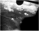 B-25 Mitchell bombers fly over a large city in the CBI during WWII, in 1943.