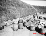 Fuel barrels in a flooded revetment in Yunnan province, China, most likely at the Luliang air base area. During WWII.