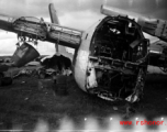 An image from the Roubinek Collection, showing a wrecked and broken-backed B-24 bomber in a boneyard near the base. in Yunnan province, China, most likely around the Luliang air base area.