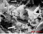 Streetside shoe repair in Yunnan, China, during WWII.