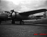 A B-25 with Nationalist markings, tail number #B31205, with bombs laid out ready for loading, at the American air base at Luliang in WWII in Yunnan province, China.