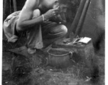 Frank G. Ehle shaving in a tent along the Burma Road during WWII.