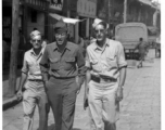 American GIs walking down the road in China during WWII, probably in Yunnan province (based on the architecture in the background). On the right is Frank G. Ehle.
