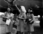 Celebrities visit and perform at Yangkai, Yunnan province, during WWII: Mary Landa, Ann Sheridan, Ruth Dennis pose with B-25 with Sheridan's image as nose art.