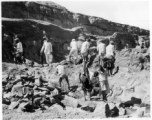 Men quarry rocks by hand.  Scenes in India witnessed by American GIs during WWII. For many Americans of that era, with their limited experience traveling, the everyday sights and sounds overseas were new, intriguing, and photo worthy.