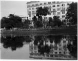 Large building and waterway in city.  Scenes in India witnessed by American GIs during WWII. For many Americans of that era, with their limited experience traveling, the everyday sights and sounds overseas were new, intriguing, and photo worthy.